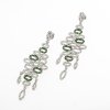 Expressive cocktail earrings set with diamonds and tsavorites