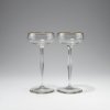 Two champagne glasses, c1899